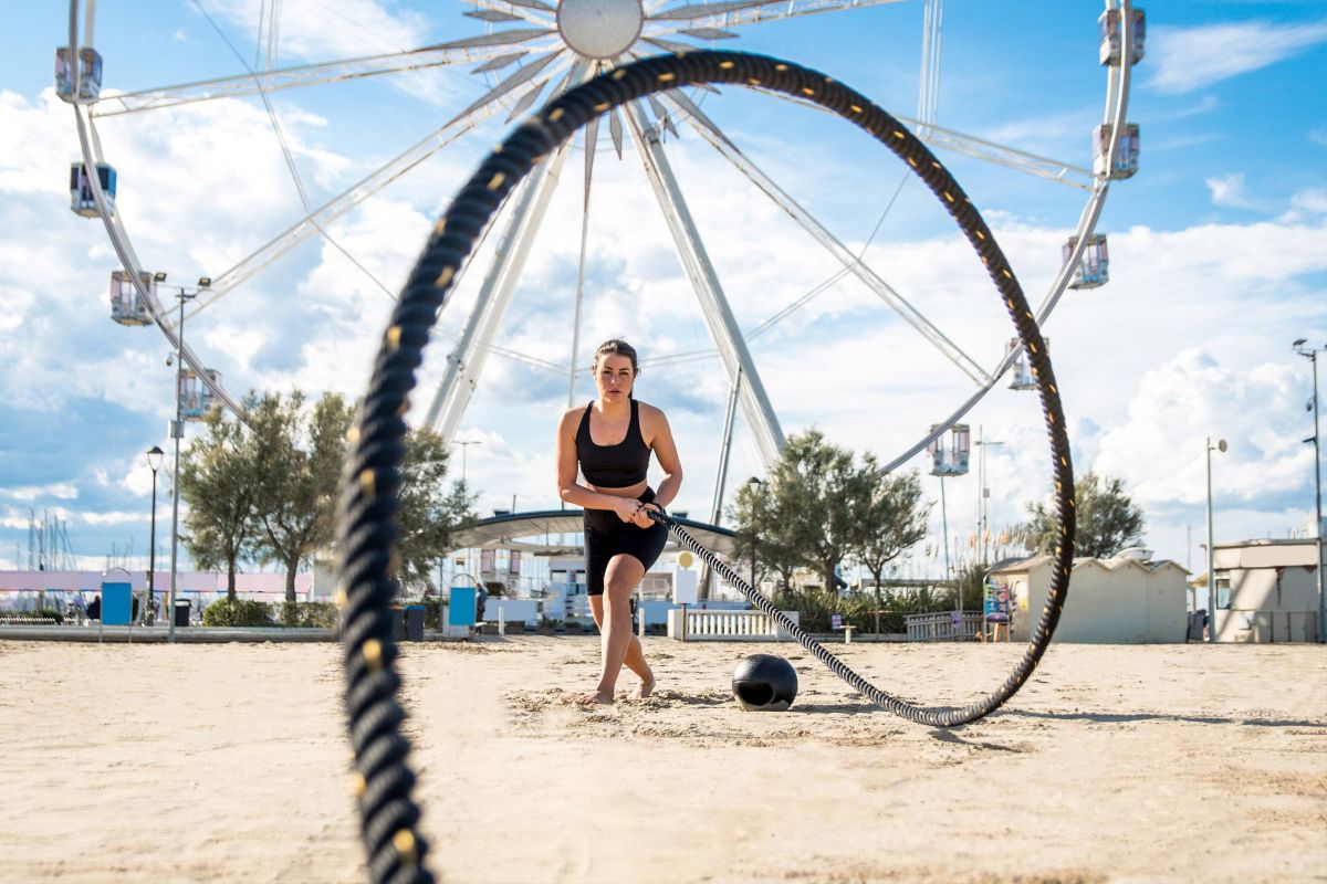 Beach woman rope exercise