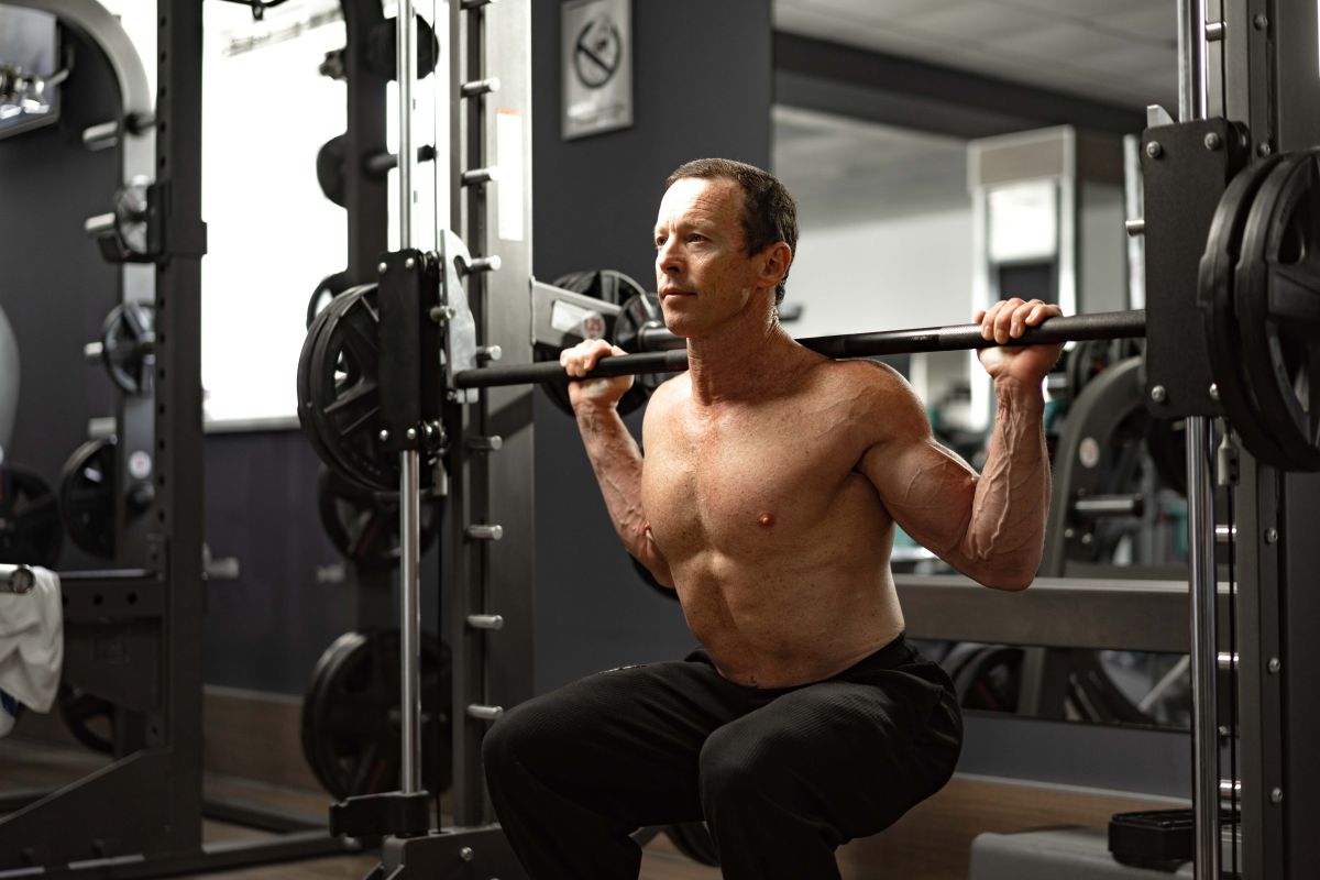 Senior man working out at the gym doing squats 2023 11 27 05 28 39 utc